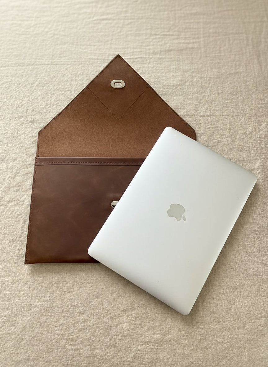Tan NZ leather laptop case with silver closure.