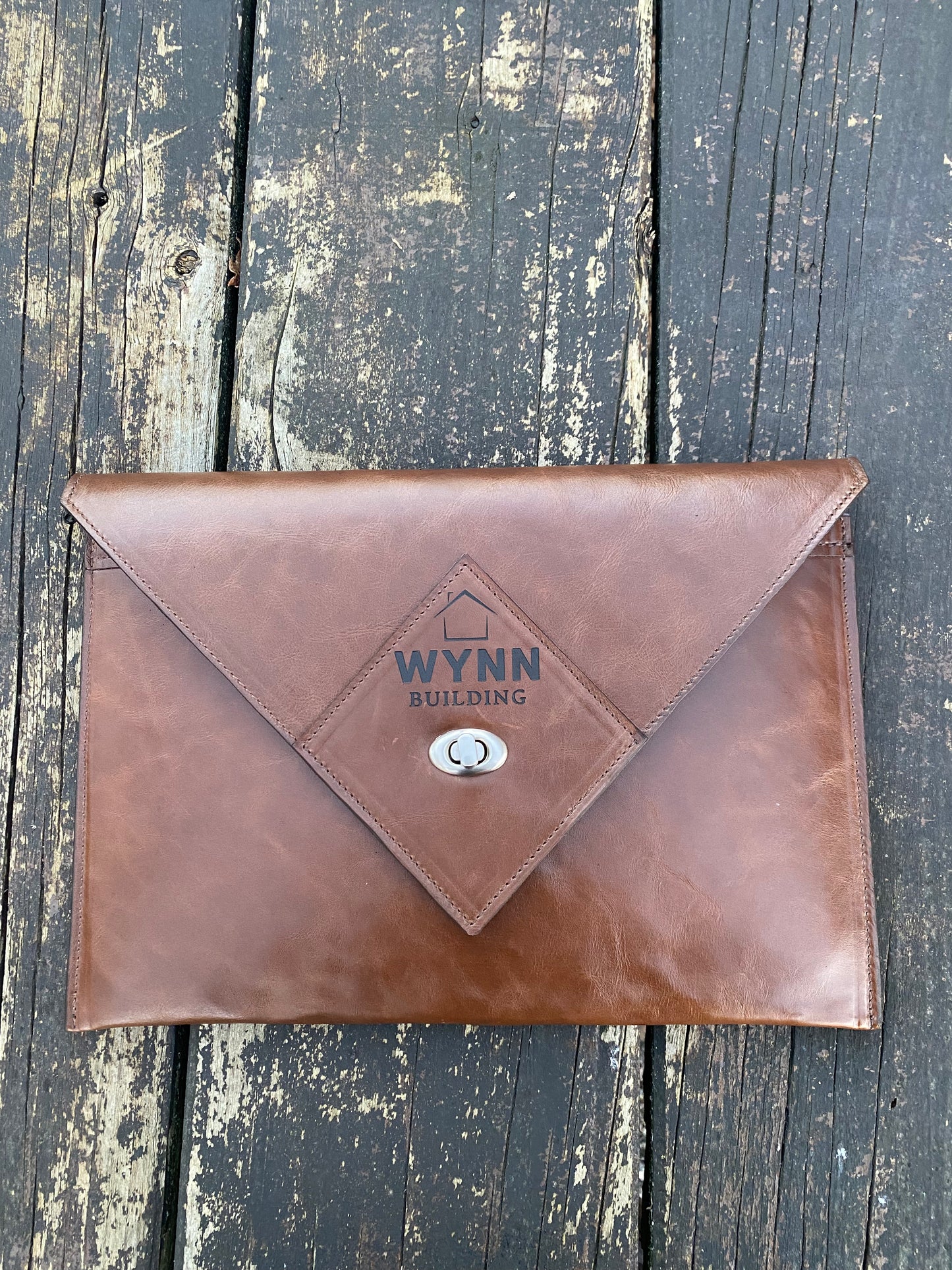 Tan NZ leather laptop case with silver closure and custom laser engraved logo