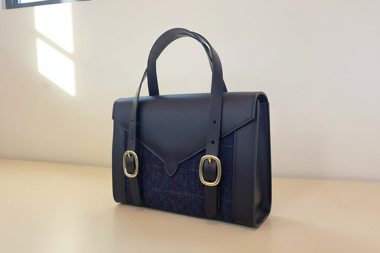 Havana Fisher Purse with navy harris tweed panels and gold hardware. Back side view.