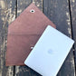 Tan NZ leather laptop case with silver closure.