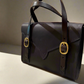 Back View of a havana Fisher Purse with gold hardware. 